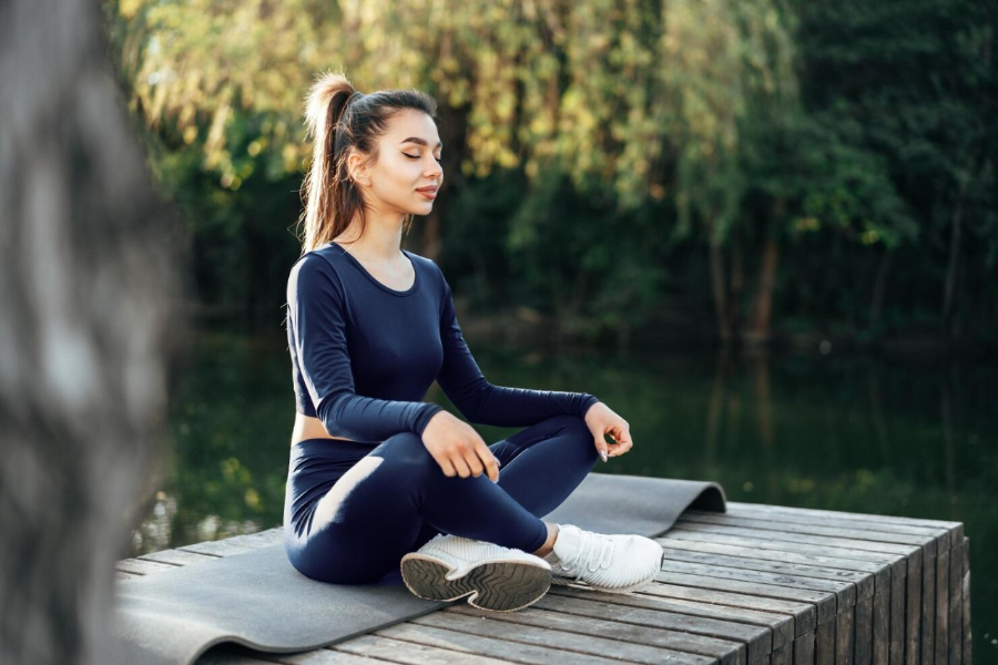 Person seated in a calm outdoor wellness setting